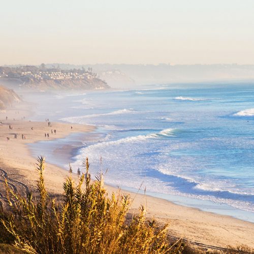 The-Carlsbad-coast-in-the-daytime-with-waves-crashing-onto-sandy-beaches